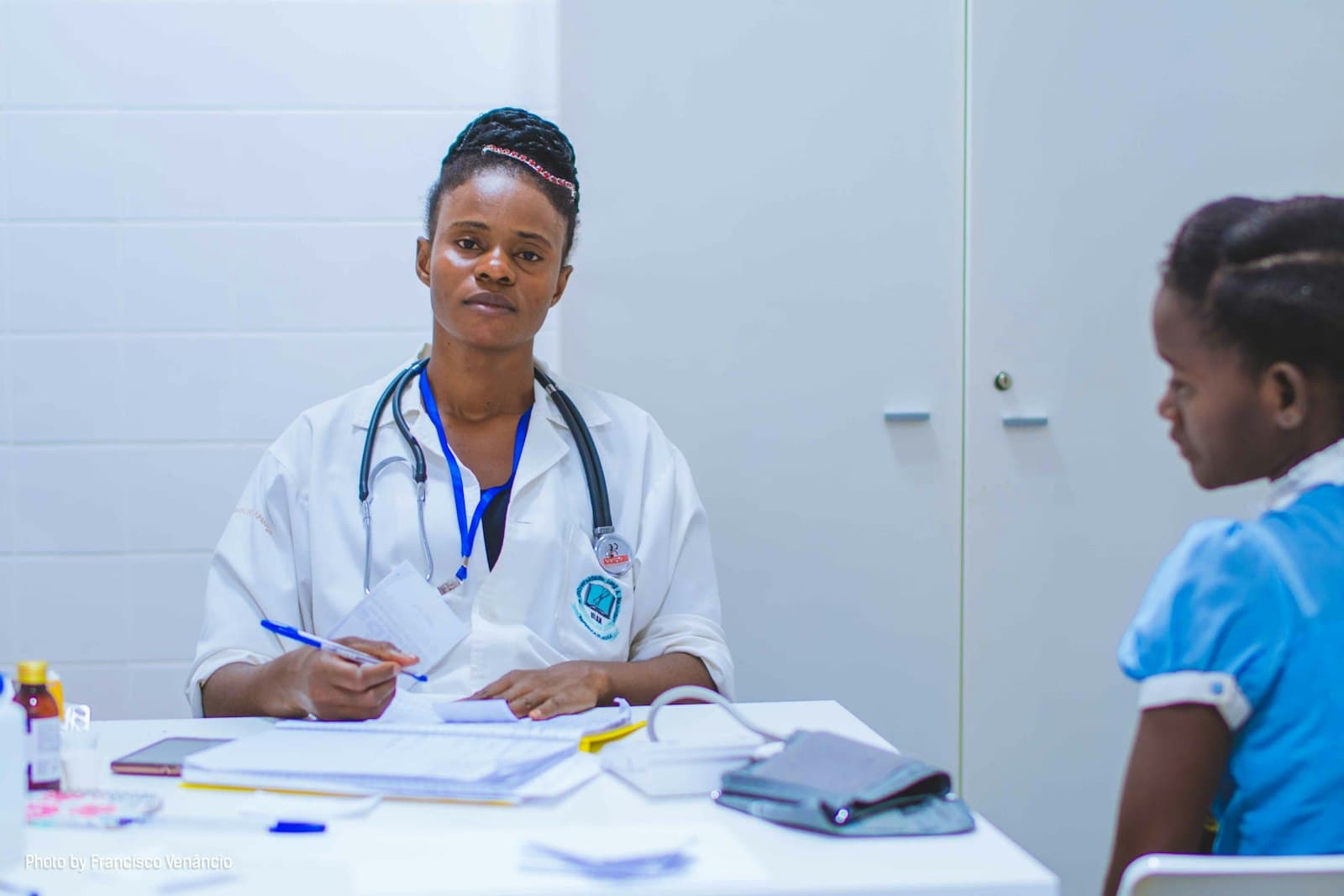 Doctor consulting with a young patient at her desk